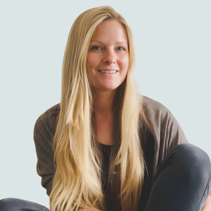 Inga Mehlhardt - psychologische Beraterin Eine einladend lächelnde Frau mit langen, blonden Haaren sitzt entspannt.